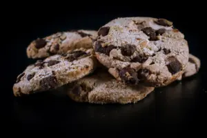 Fresh chocolate chip cookies cooling on a wire rack